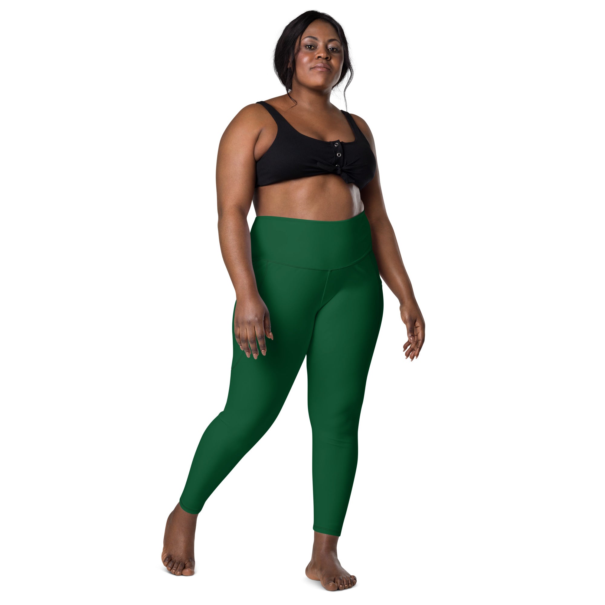 Women’s dark green high-waisted yoga leggings with pockets made from soft compression fabric for active use
