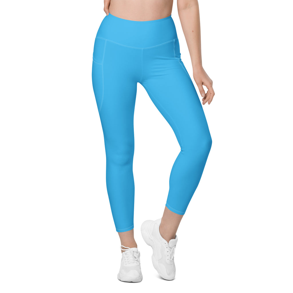 Women’s bright blue high-waisted yoga leggings with smooth stretchy fabric and side pockets for soft compression activewear