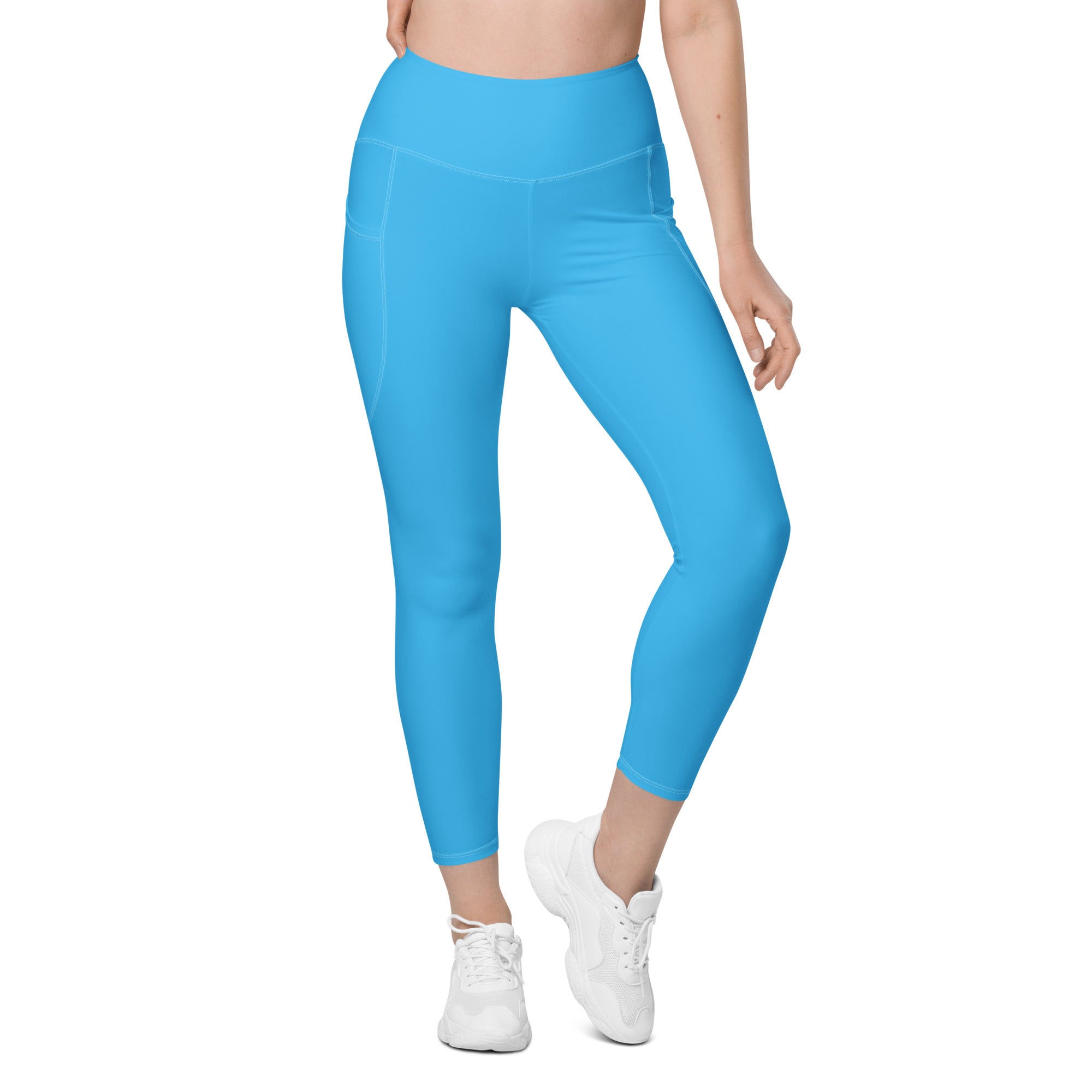 Women’s bright blue high-waisted yoga leggings with smooth stretchy fabric and side pockets for soft compression activewear