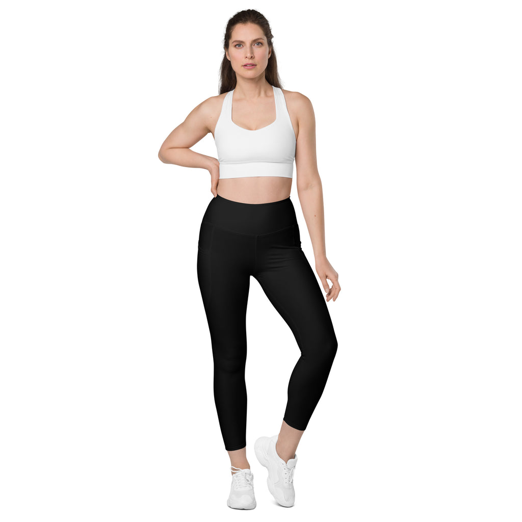Women’s black high-waisted yoga leggings with pockets made of soft compression material and cropped hemline