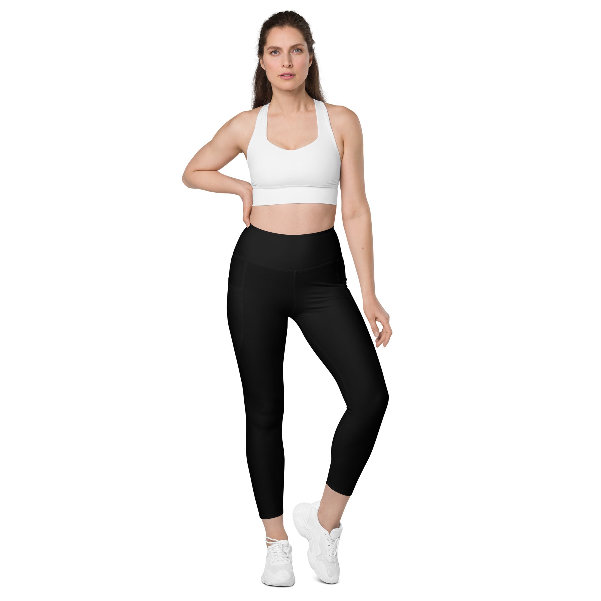 Women’s black high-waisted yoga leggings with pockets made of soft compression material and cropped hemline