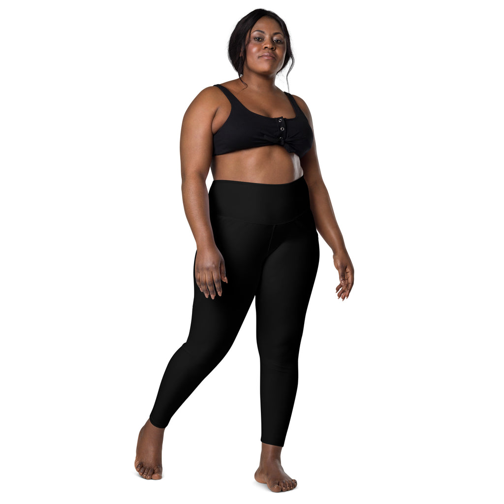 Women’s black high waisted yoga leggings with pockets made of soft compression material and a smooth fit