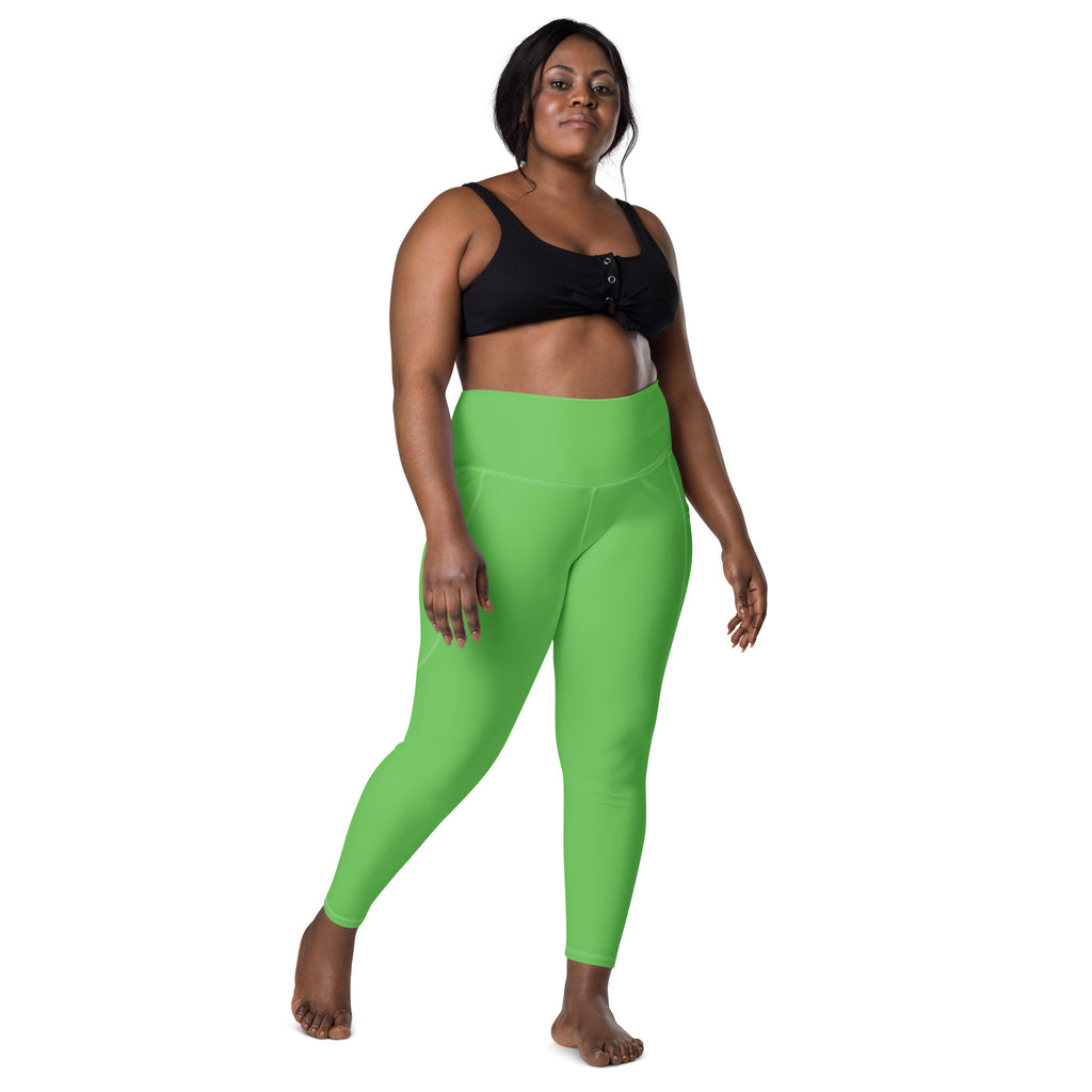 Women’s bright green high-waisted yoga leggings with pockets made of soft compression fabric for active wear