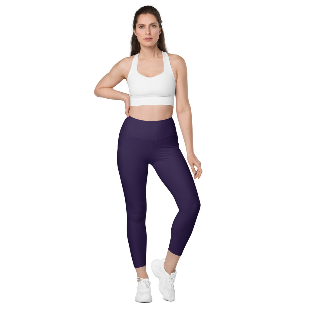 A pair of high-waisted dark purple yoga leggings with pockets made of soft compression stretchy fabric