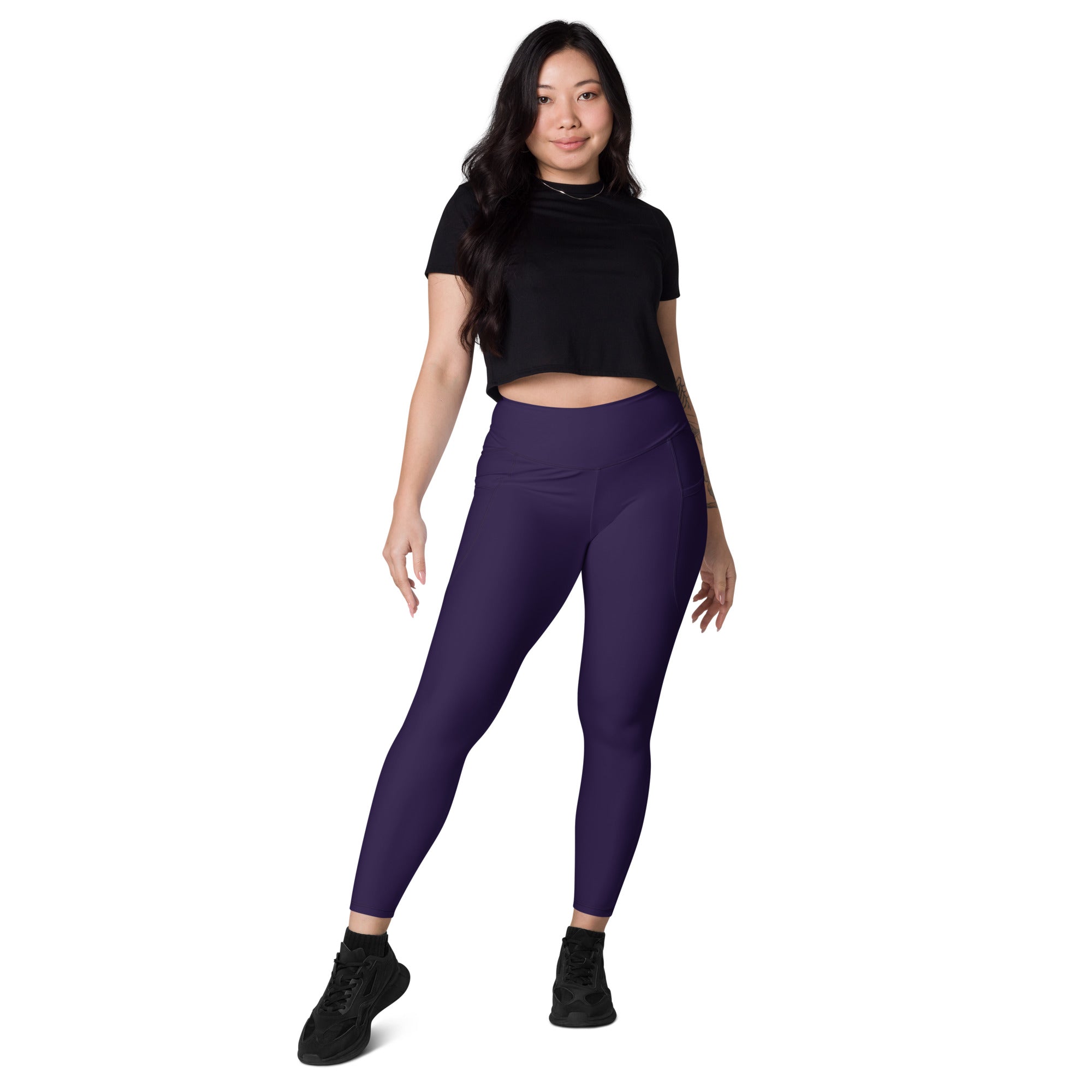 Women’s dark purple high-waisted yoga leggings with pockets made of smooth form-fitting soft compression material