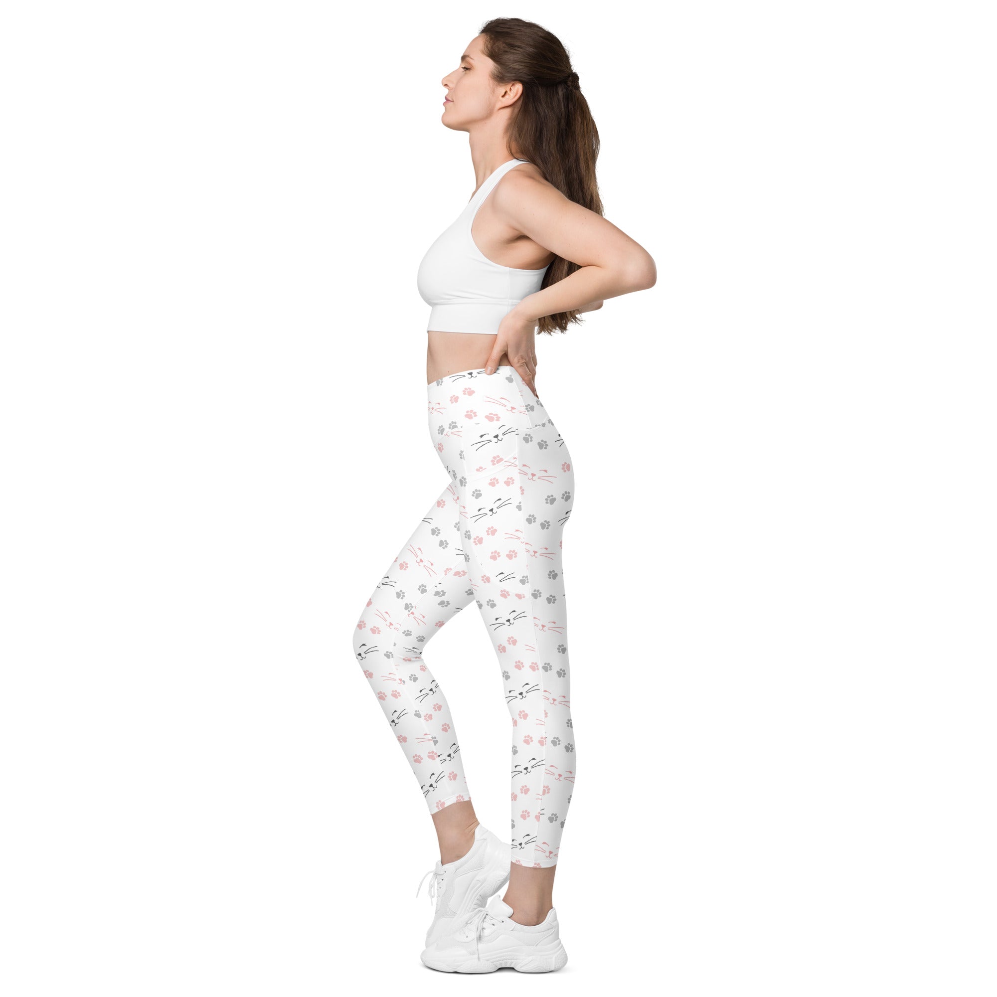 White high-waisted women’s yoga leggings with soft compression and pink and gray cat paw print pattern with pockets