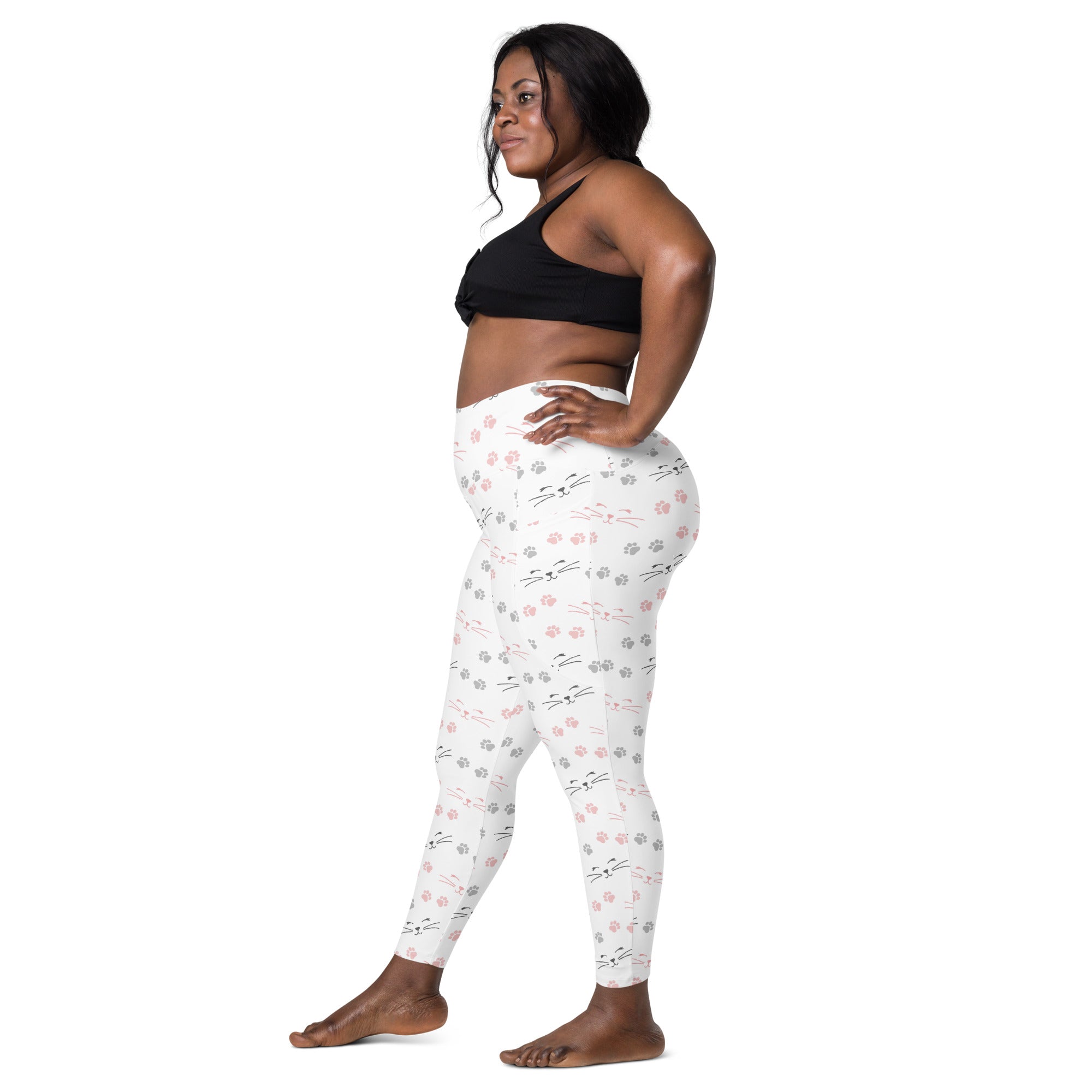 Women’s white high waisted cat paw print yoga leggings with soft compression and pockets featuring pink and gray cat faces