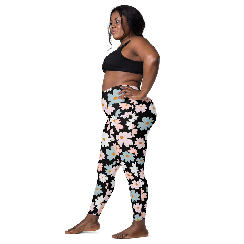 Black high-waisted women’s retro floral yoga leggings with pockets featuring pink white and blue daisies on soft compression fabric