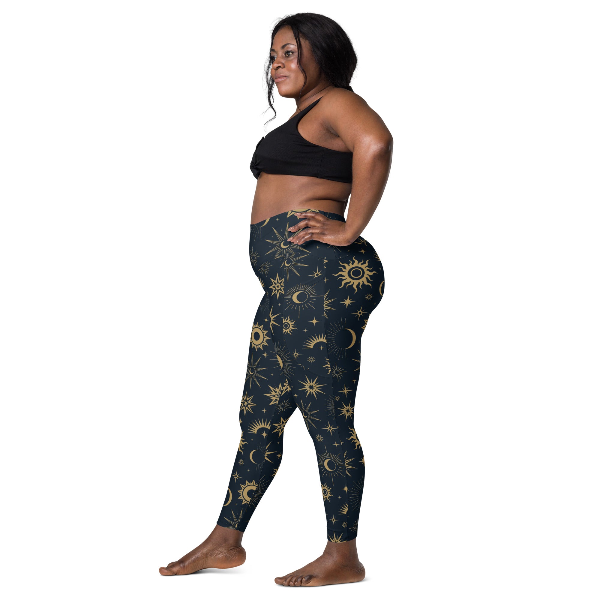 Dark blue women’s high waisted yoga leggings with vibrant gold celestial sun moon and star pattern and pockets