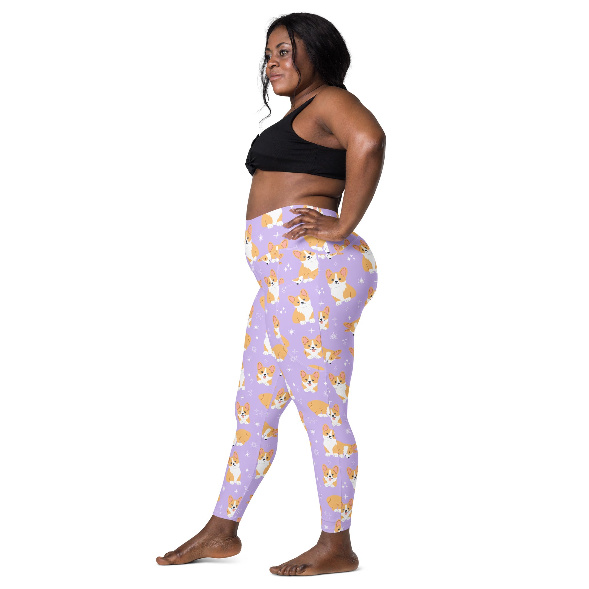 Women’s purple high-waisted leggings with pockets featuring a repeating tan and white cartoon corgi pattern