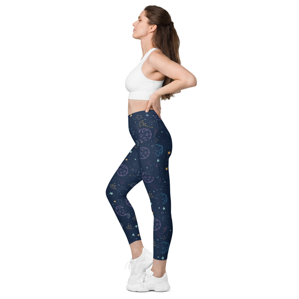Dark blue high-waisted women’s galaxy space yoga leggings with pockets and soft pastel moons stars and planets pattern