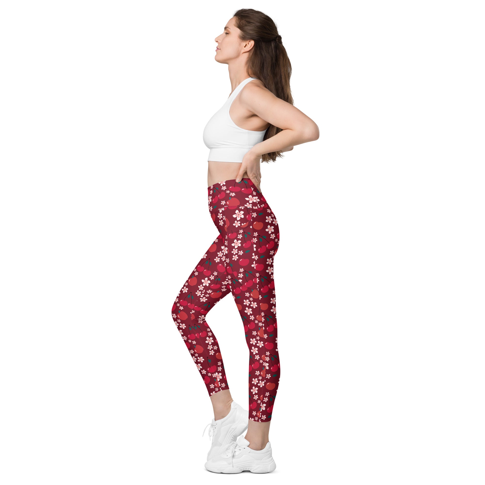 Women’s cherry blossom yoga leggings with pockets feature a red floral pattern with white and pink blossoms on dark red background