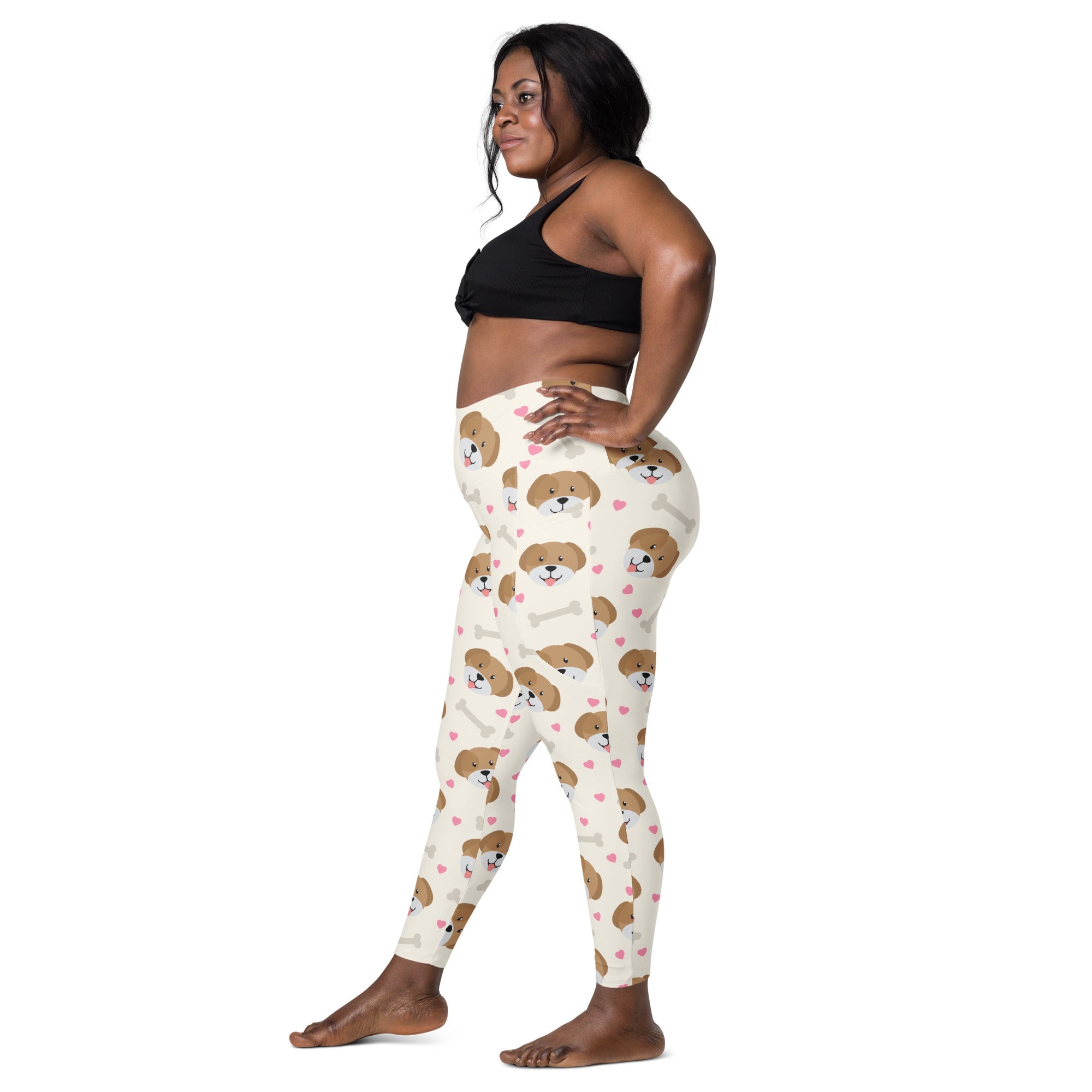 Cream-colored women’s cute dog yoga leggings with pockets featuring brown puppy faces pink hearts and white bones pattern
