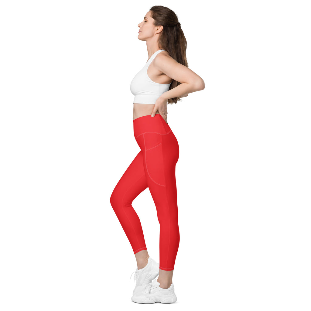 Women’s vibrant red high-waisted soft compression yoga leggings with sleek form-fitting design and side pockets