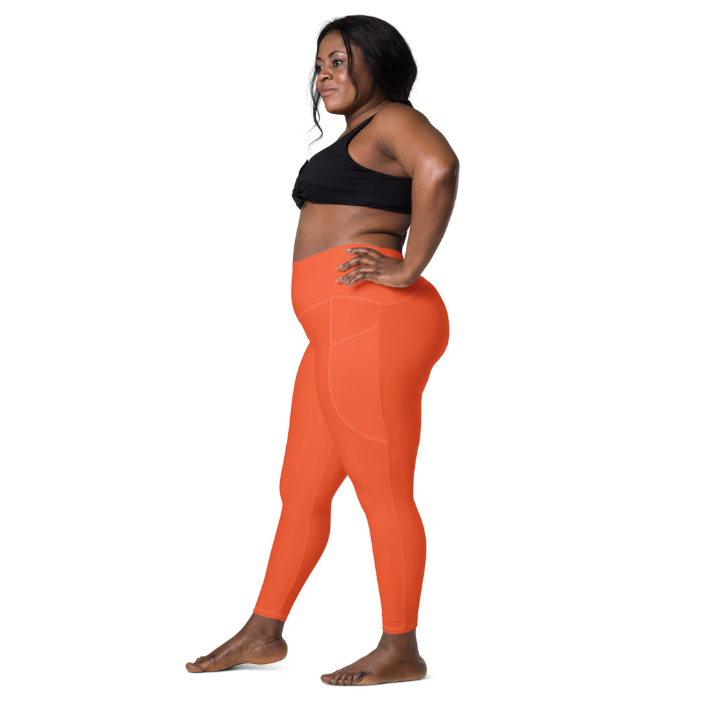 Women’s orange high-waisted yoga leggings with soft compression stretch fabric and side pockets for active wear