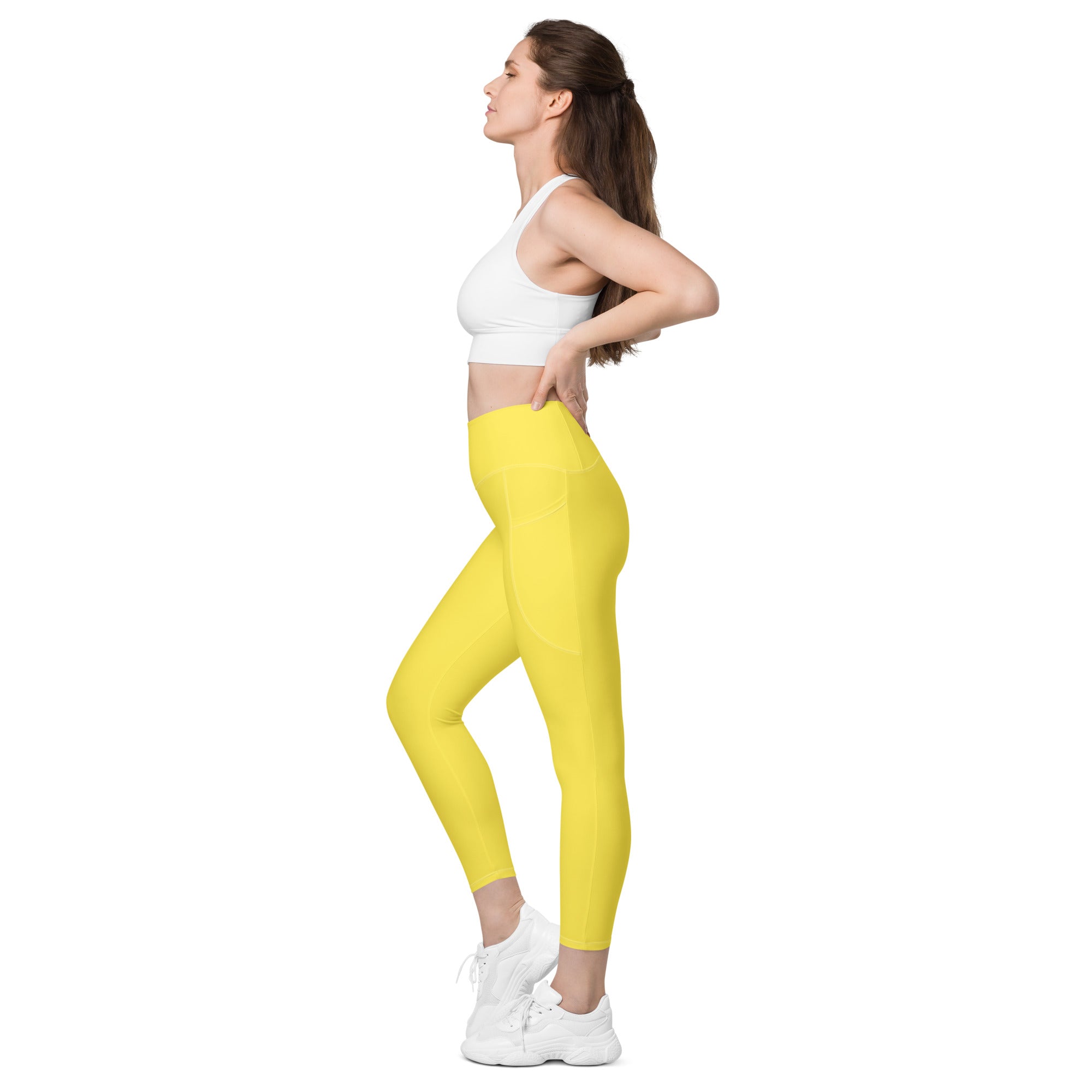 Women’s yellow high-waisted yoga leggings with pockets made of smooth stretchy fabric for soft compression and active wear