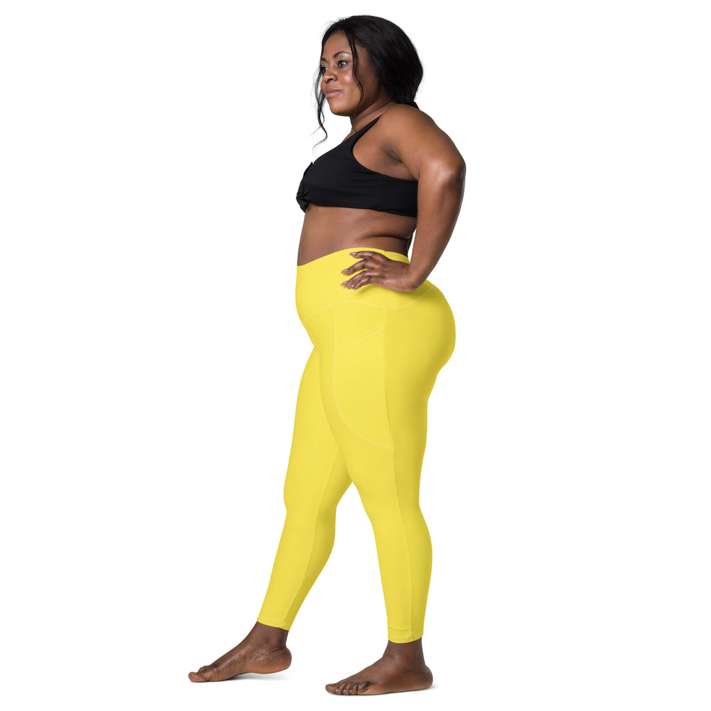 Women’s bright yellow high-waisted yoga leggings with pockets made of soft compression fabric for active wear