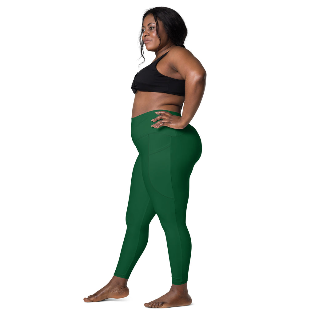 A pair of forest green high-waisted yoga leggings with pockets made from soft compression stretchy fabric