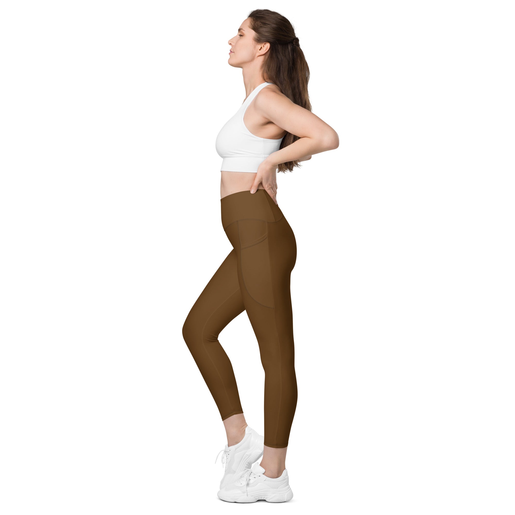Women’s brown high-waisted yoga leggings with pockets made from smooth, form-fitting soft compression material