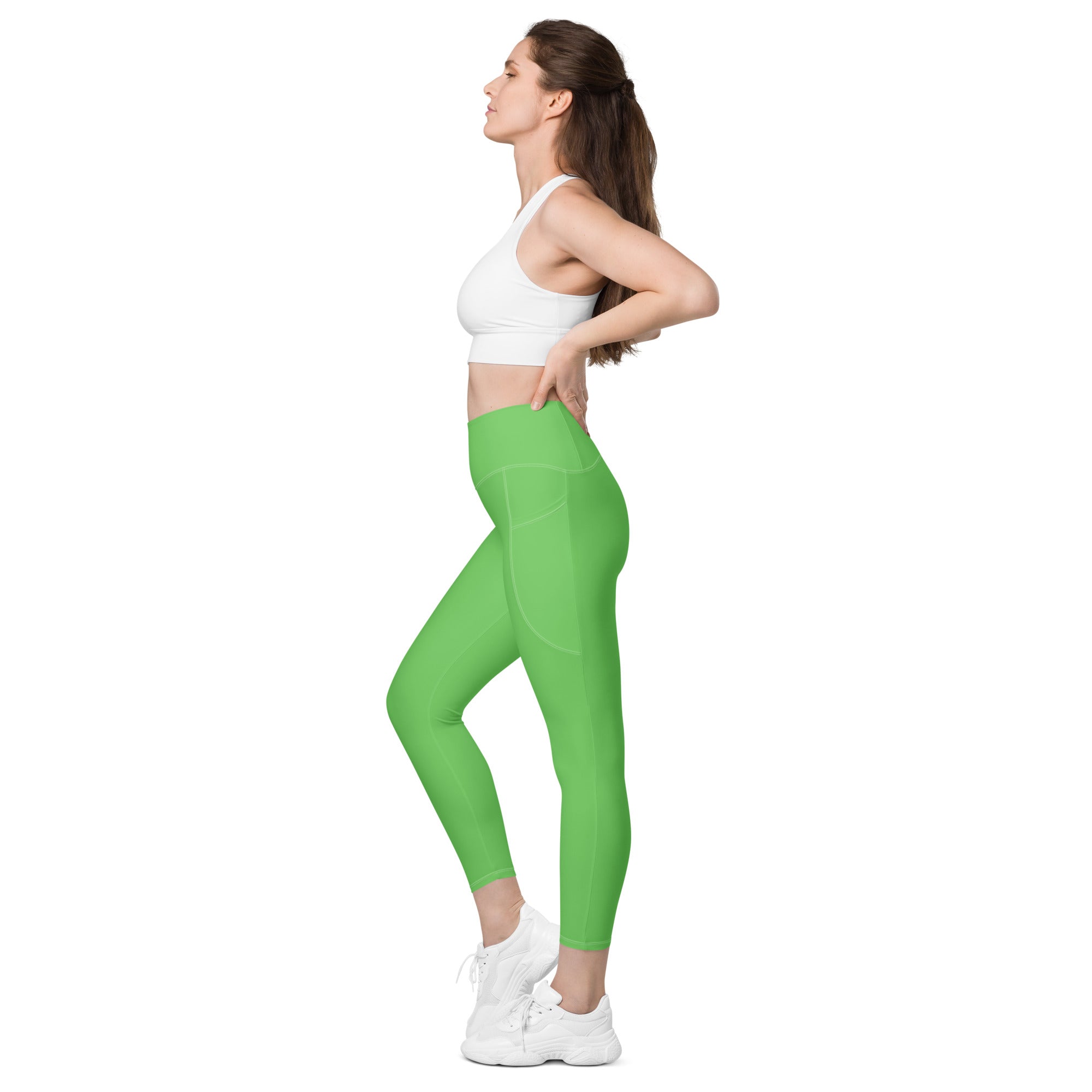 Women’s bright green high-waisted yoga leggings with pockets made of smooth, soft compression fabric
