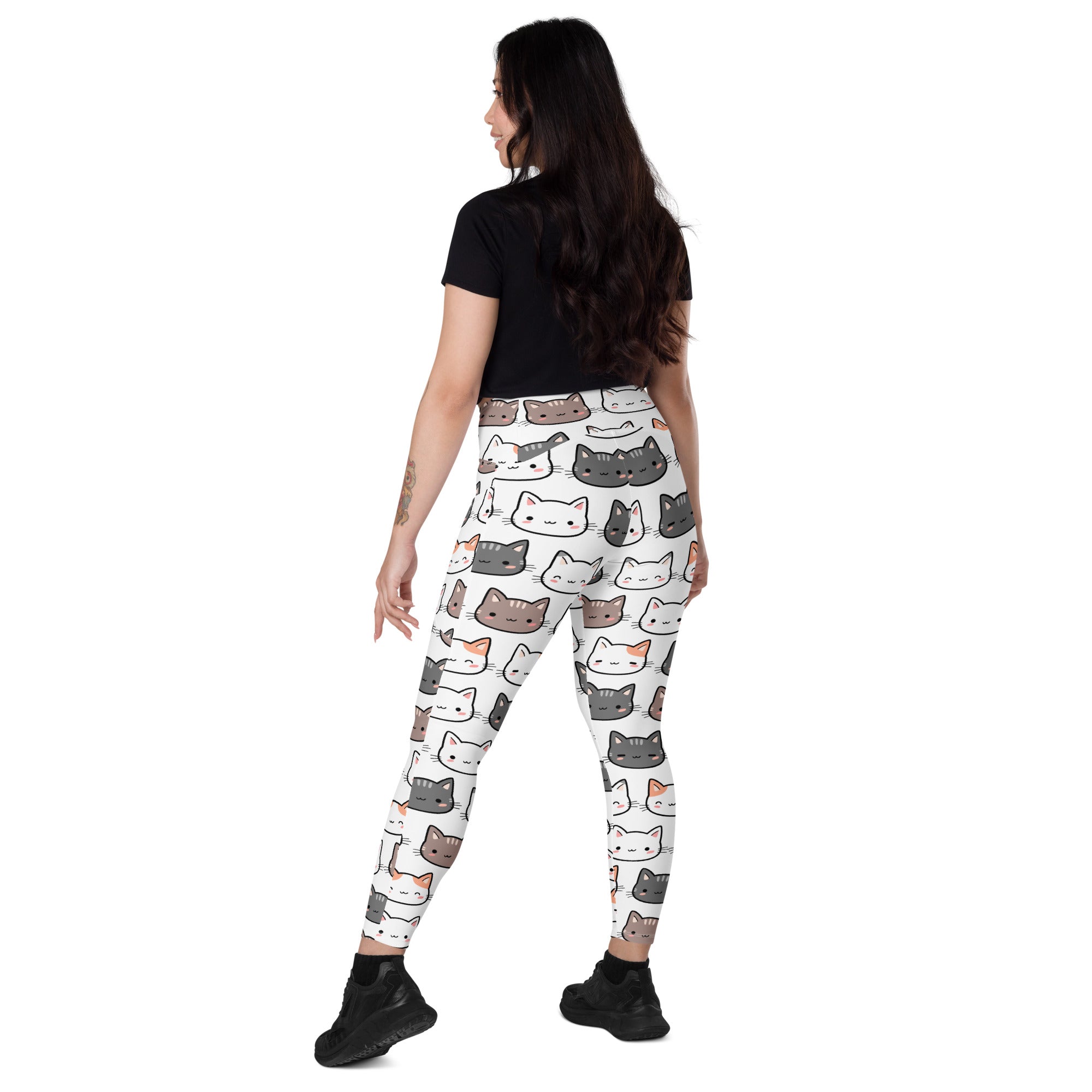 White women’s high-waisted yoga leggings with pockets featuring playful multicolored cartoon cat pattern
