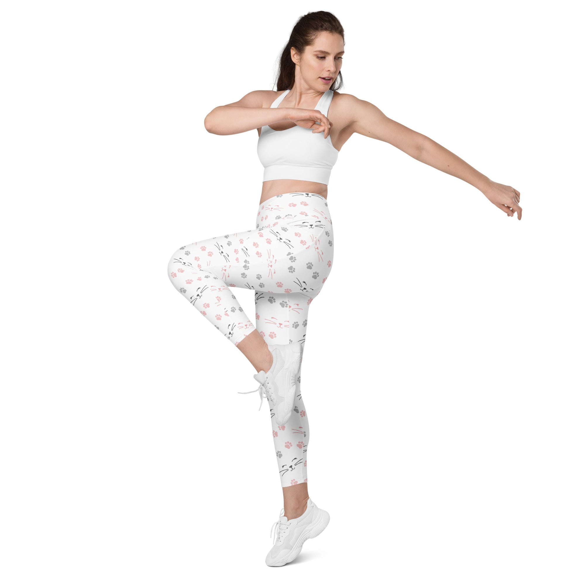 White women’s high-waisted yoga leggings with soft compression and pink gray cat faces and paw print pattern with pockets