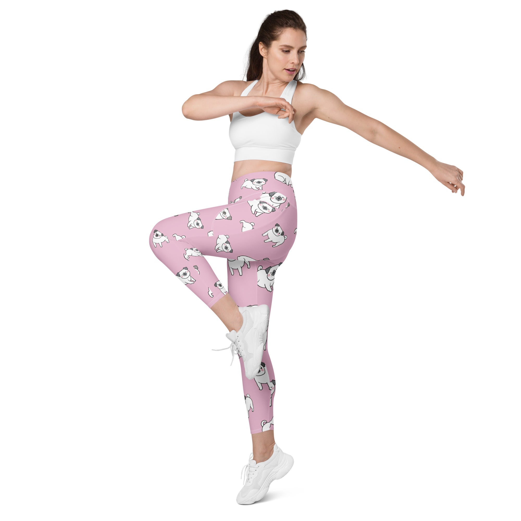 Women’s pink high-waisted yoga leggings with soft compression and pockets featuring white cartoon pug pattern
