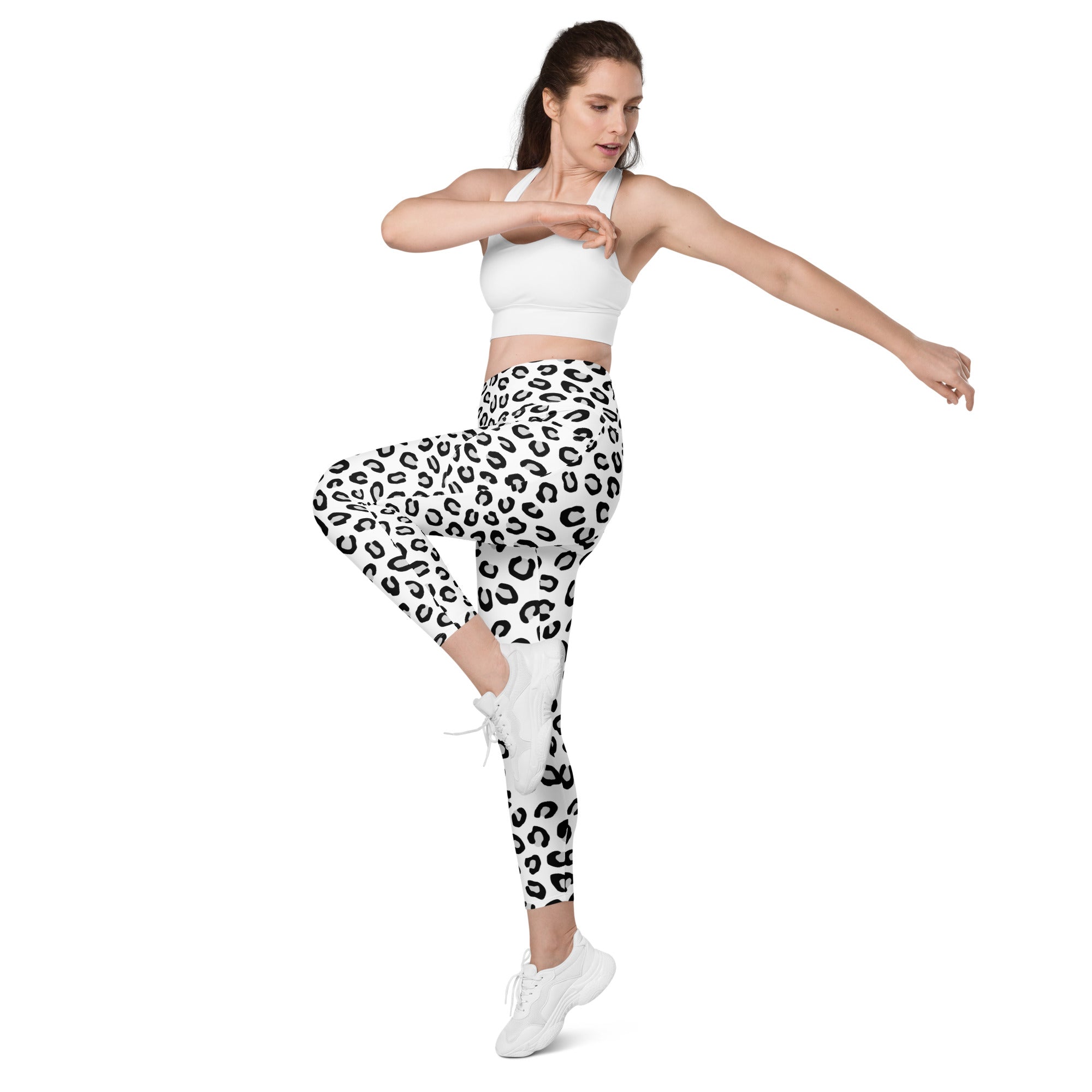 Women’s white high-waisted yoga leggings with bold black leopard print soft compression and pockets