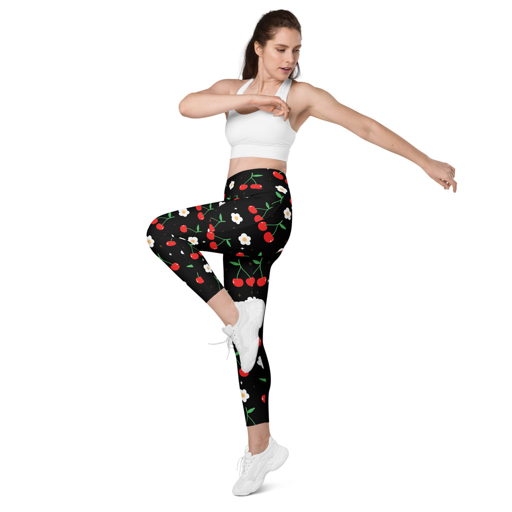 Women’s high-waisted black cherry print yoga leggings with pockets featuring vibrant red cherries and white flowers