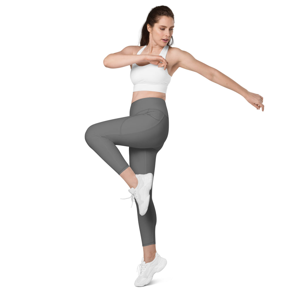 A woman wearing women’s gray high-waisted yoga leggings with pockets and soft compression paired with white shoes