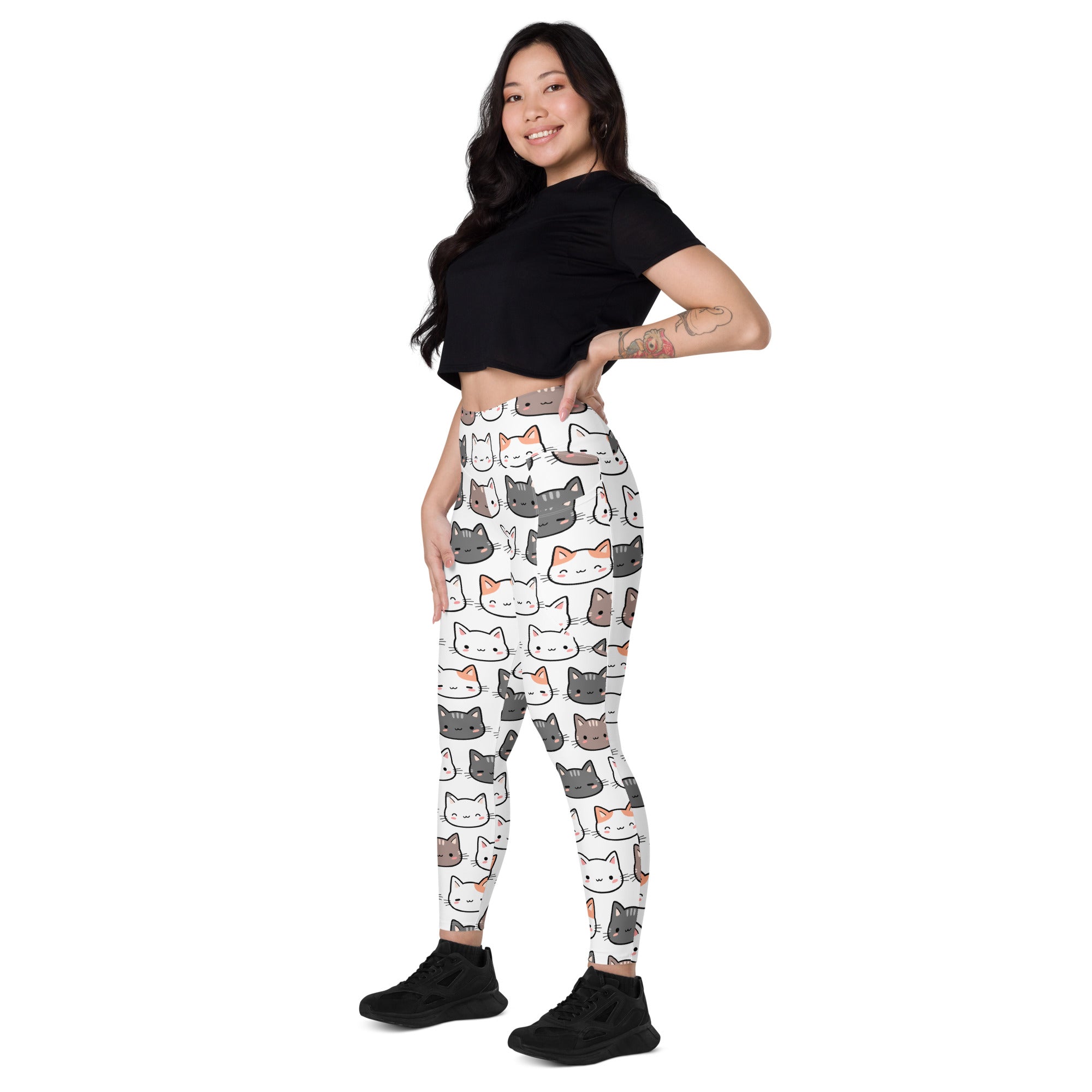White high-waisted women’s yoga leggings with soft compression and colorful cartoon cat pattern and pockets
