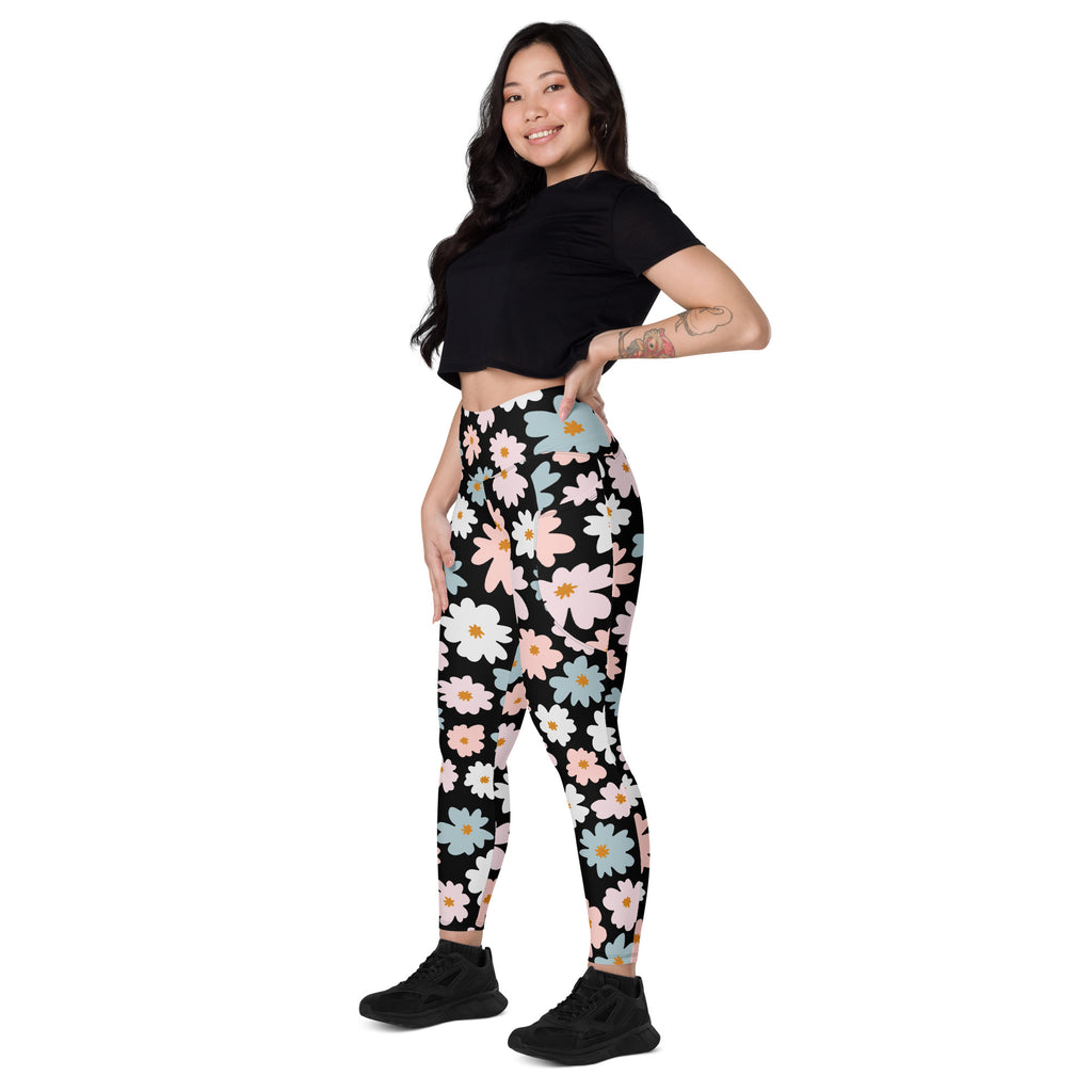 Women’s retro floral yoga leggings with pockets feature a black base and vibrant pink white light blue daisy pattern
