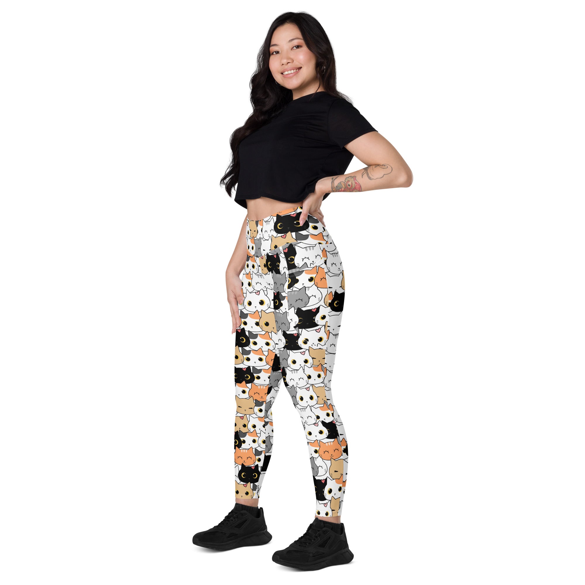 White high-waisted yoga leggings with black white gray and orange cartoon cat pattern and soft compression fabric
