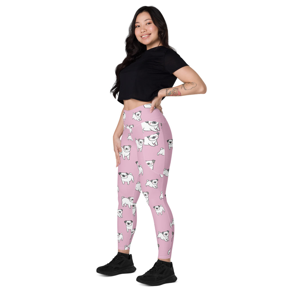 Women’s pink high-waisted yoga leggings with pockets featuring white pug illustrations and soft compression fabric