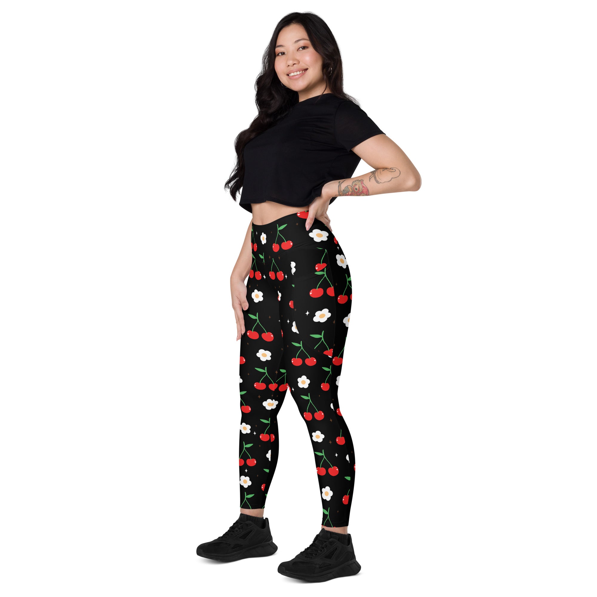 Women’s black high-waisted cherry print yoga leggings with pockets featuring red cherries white flowers and green stems