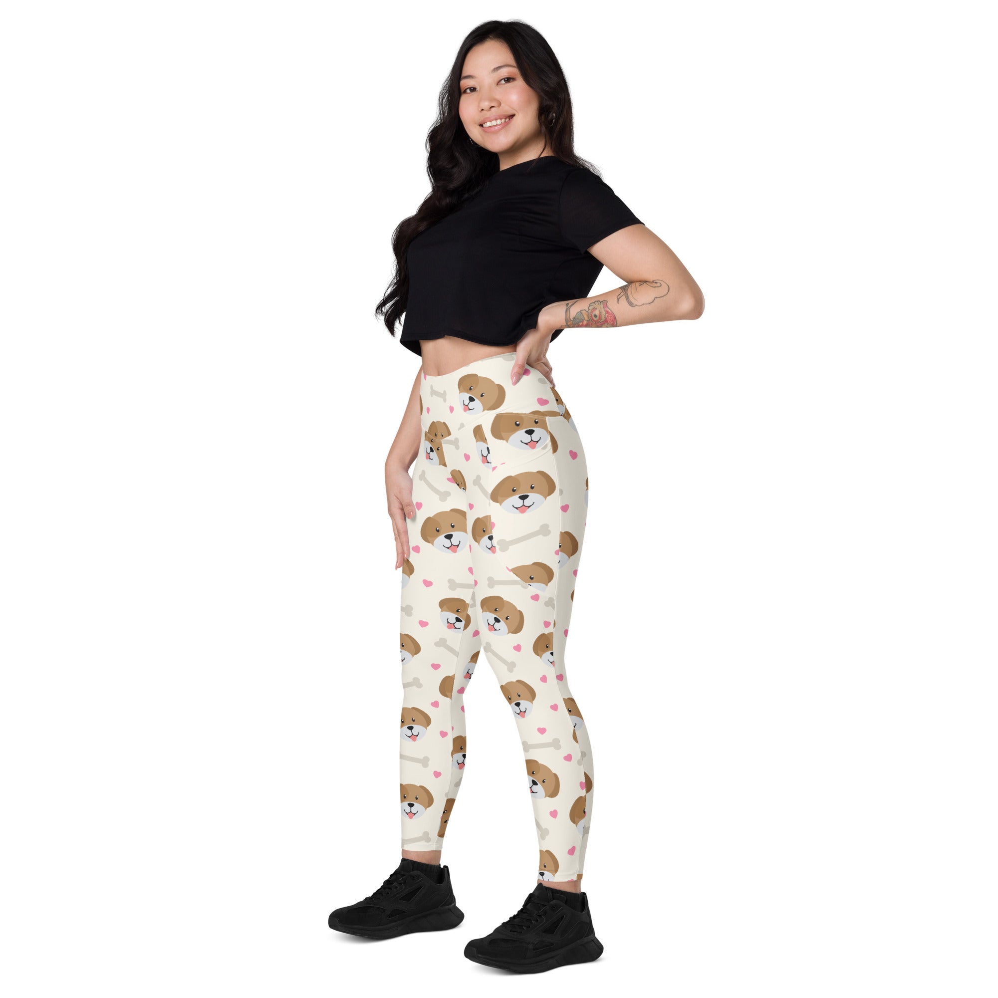 Cream-colored women’s high-waisted yoga leggings with soft compression and pockets featuring puppy faces and pink hearts