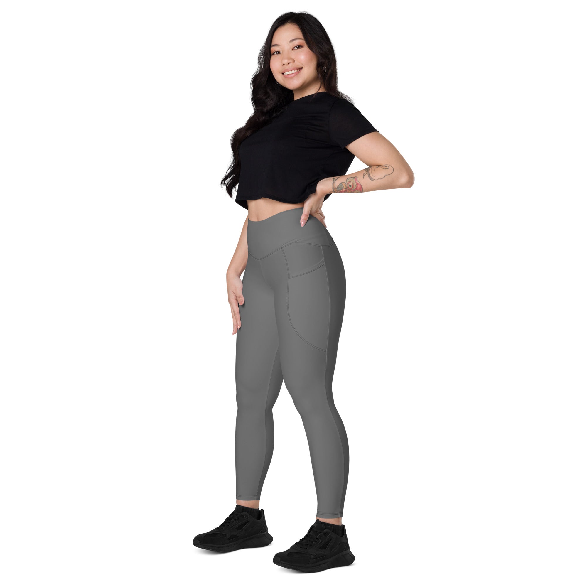 Women’s gray high-waisted yoga leggings with soft compression fabric and subtle side pockets for active wear