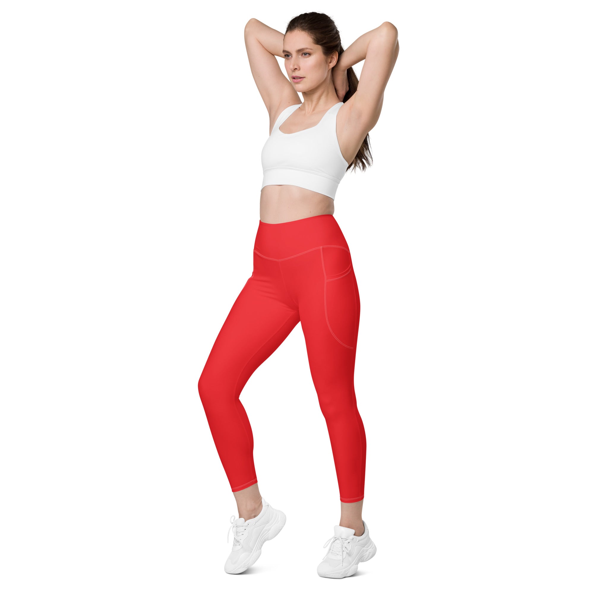 Women’s red high-waisted yoga leggings with soft compression and subtle side pockets in a sleek form-fitting design