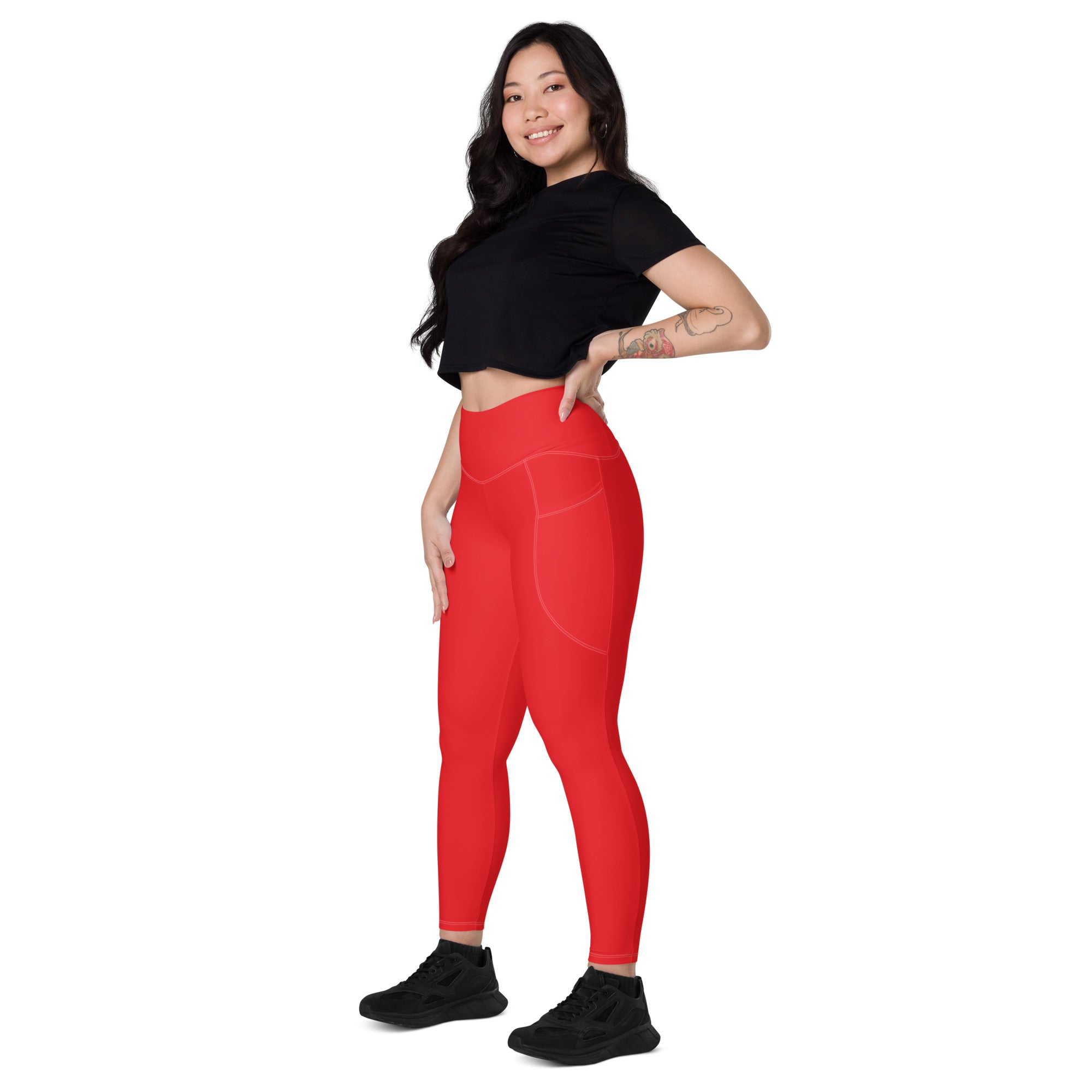 Women’s red high waisted yoga leggings with soft compression fabric and subtle side pockets for active wear
