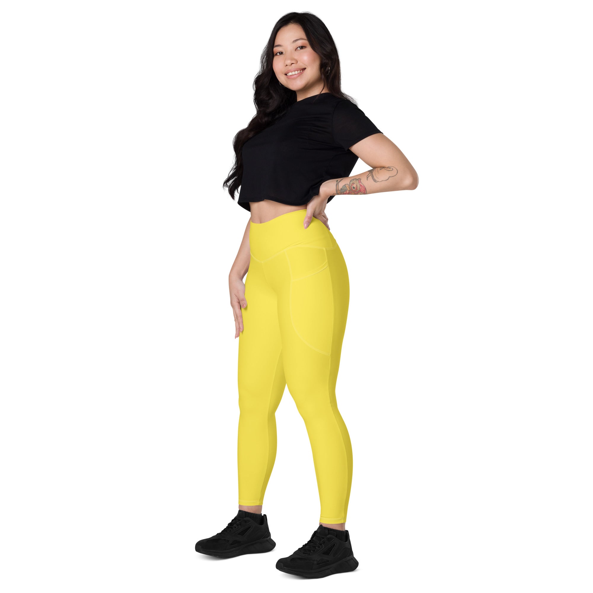 Women’s yellow high-waisted yoga leggings with pockets made of soft compression fabric for active wear