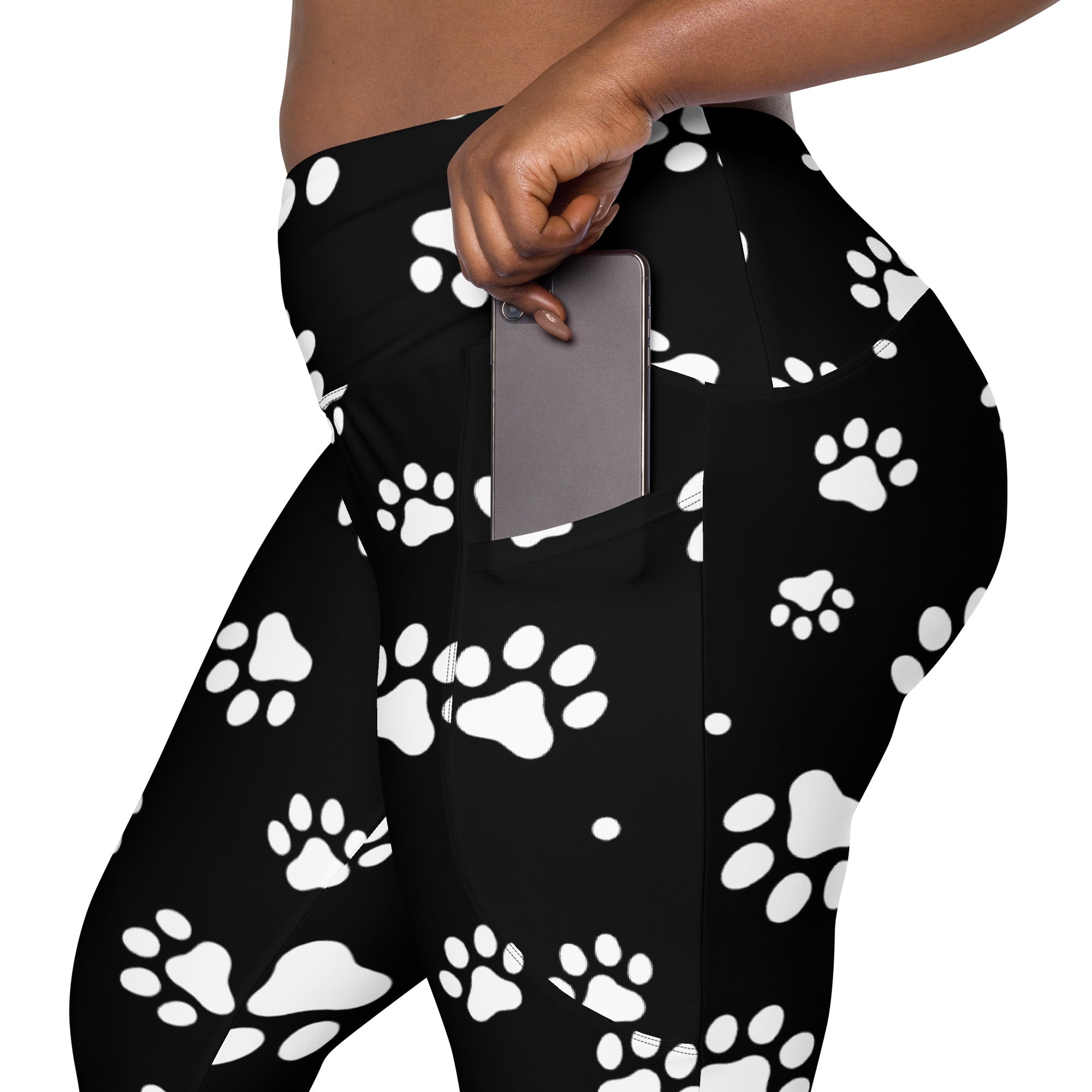 Women’s black high-waisted paw print yoga leggings with soft compression fabric and pockets for active wear