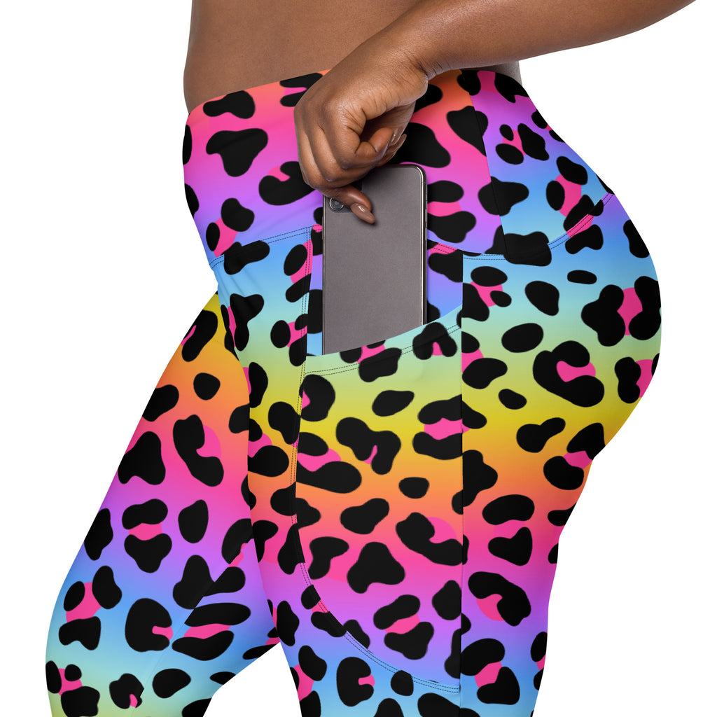 Women’s rainbow leopard high-waisted yoga leggings with soft compression fabric and side pocket holding a smartphone