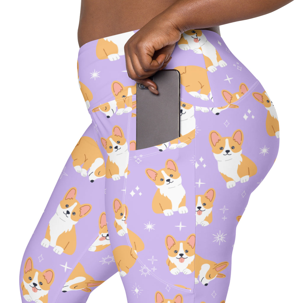 Women’s purple high-waisted yoga leggings with pockets featuring playful orange and white corgis and star sparkles