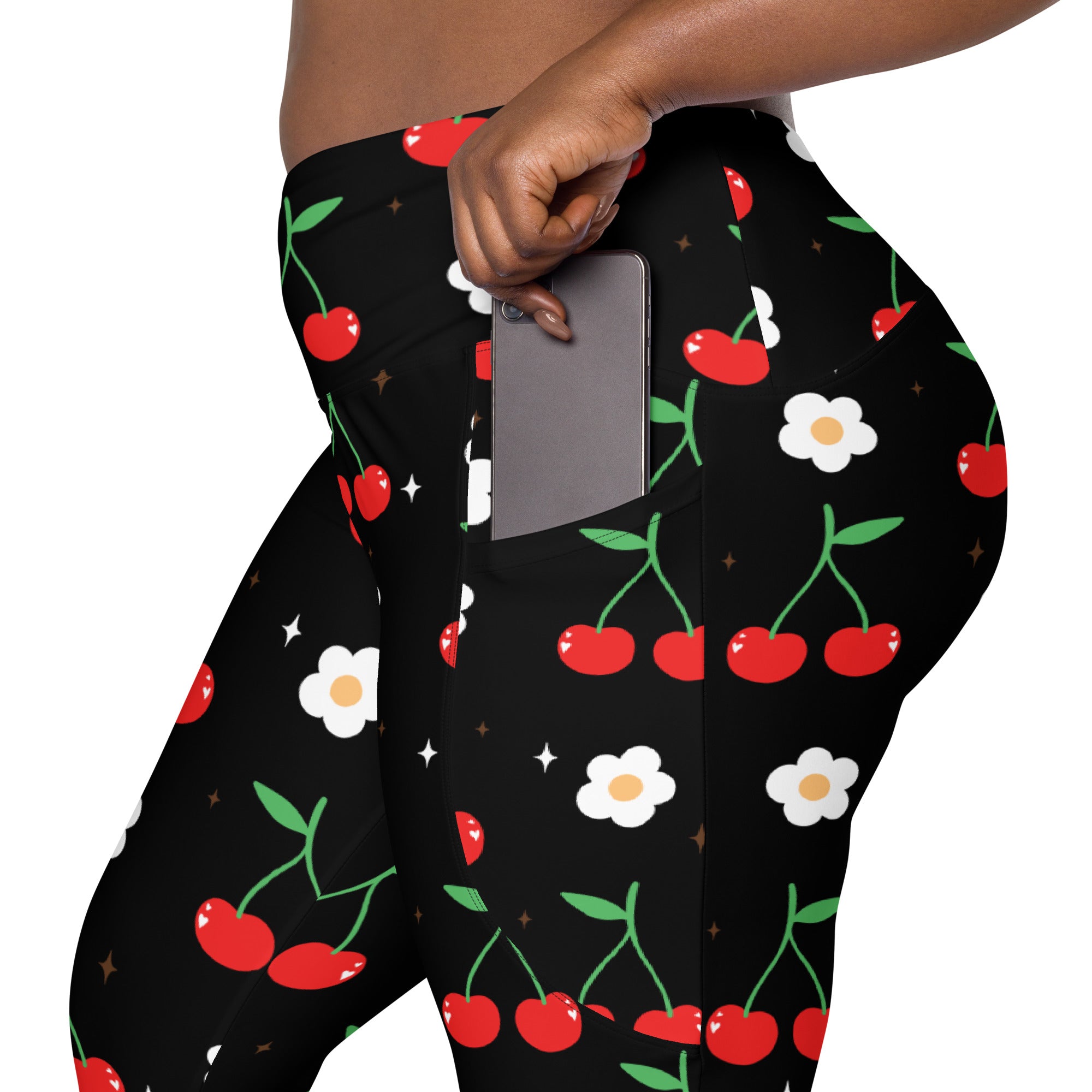 Women’s high-waisted black cherry print yoga leggings with pockets featuring red cherries and white daisies pattern