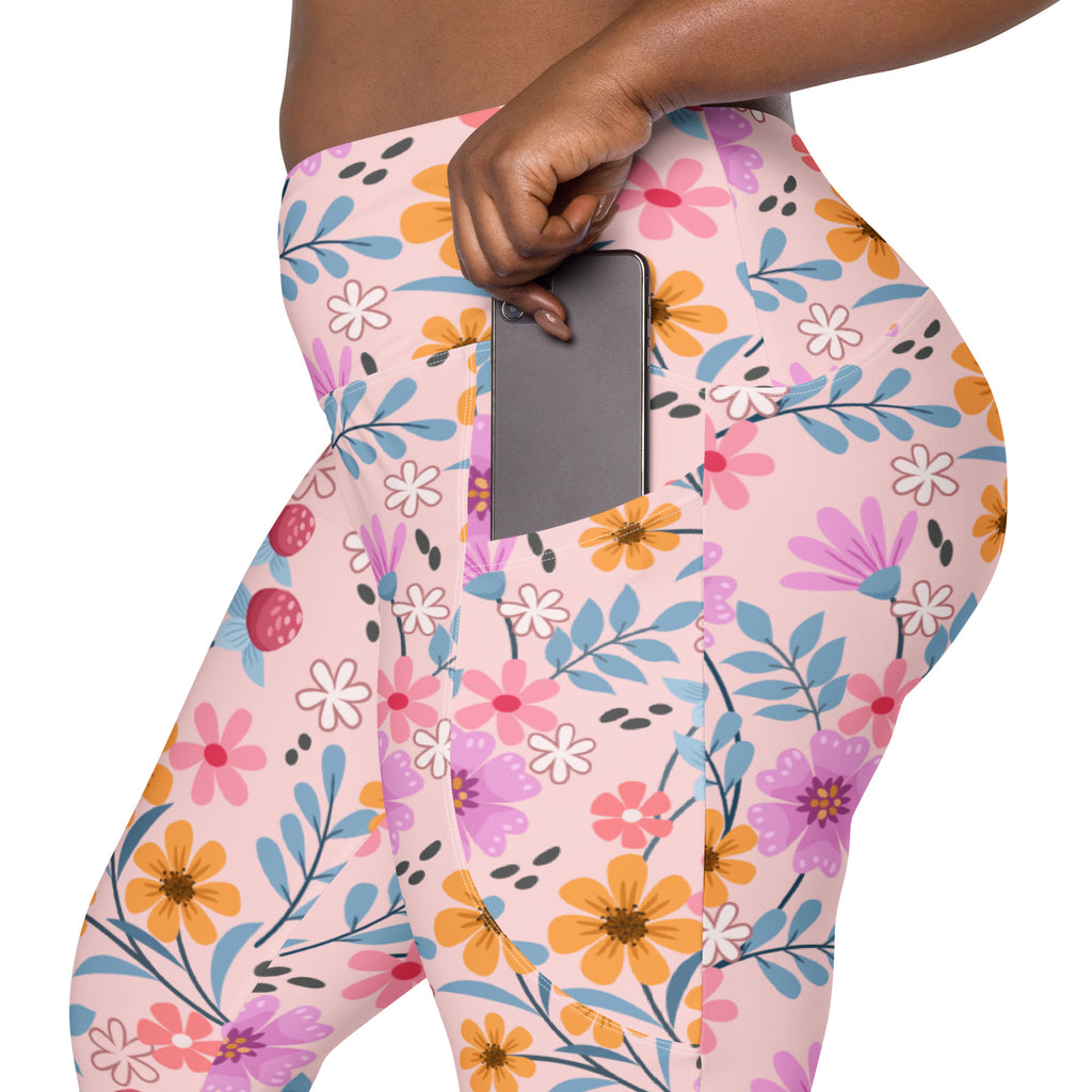 Women’s pink floral yoga leggings with pockets featuring vibrant orange purple and blue flowers and soft compression fabric