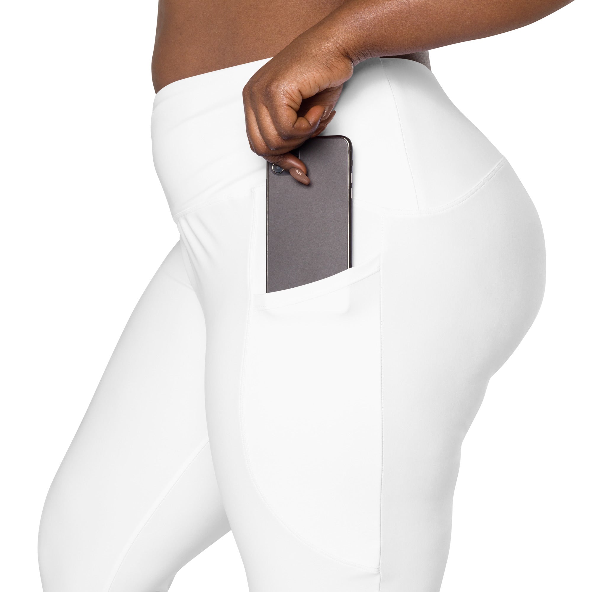Women’s white high-waisted yoga leggings with soft compression fabric and side pocket holding a smartphone