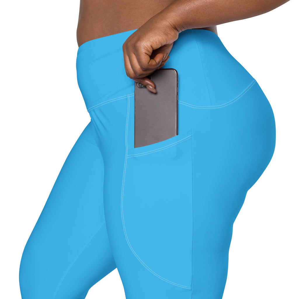 Bright blue high-waisted women’s yoga leggings with soft compression fabric and side pocket holding a smartphone