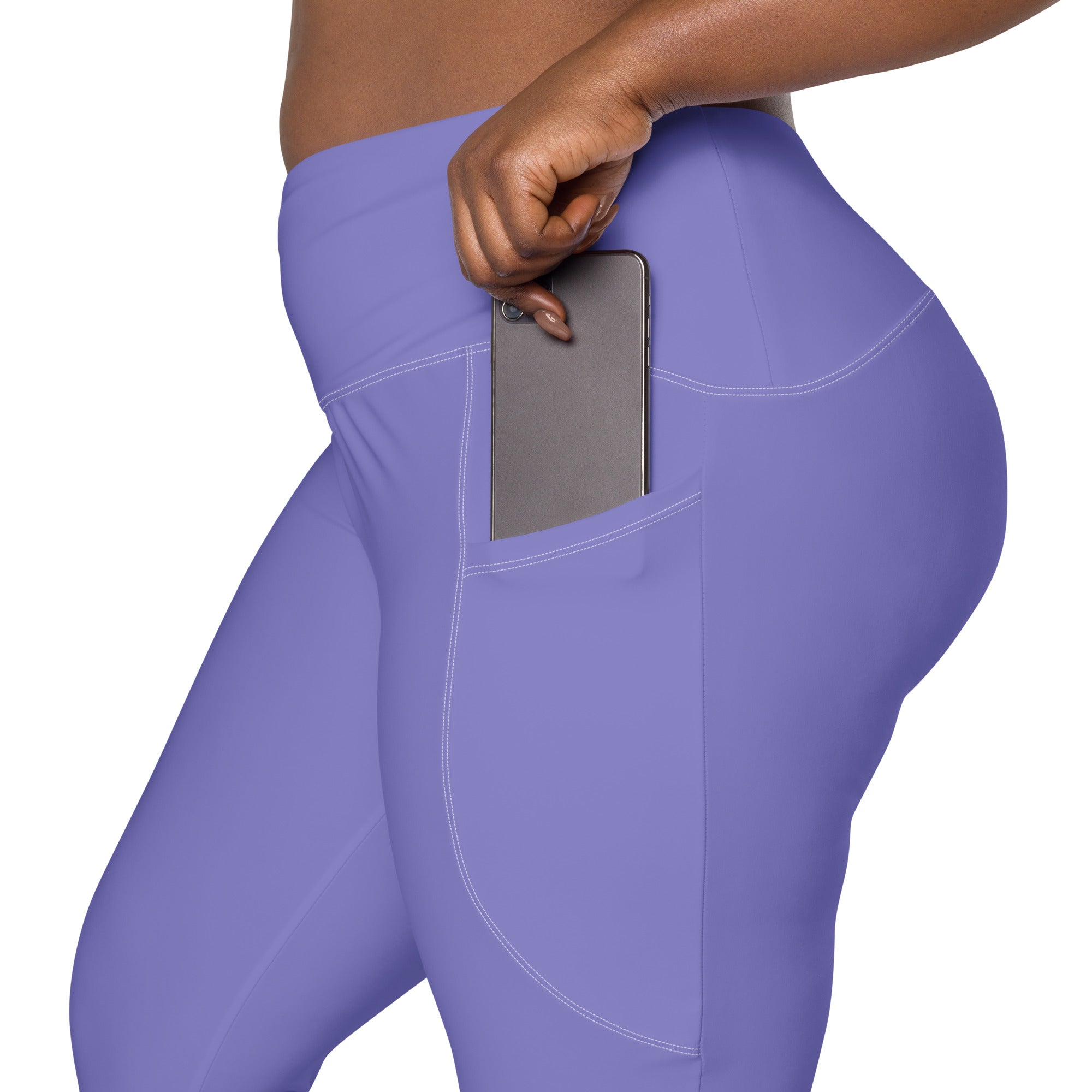 Purple high-waisted women’s yoga leggings with soft compression and side pocket holding a smartphone
