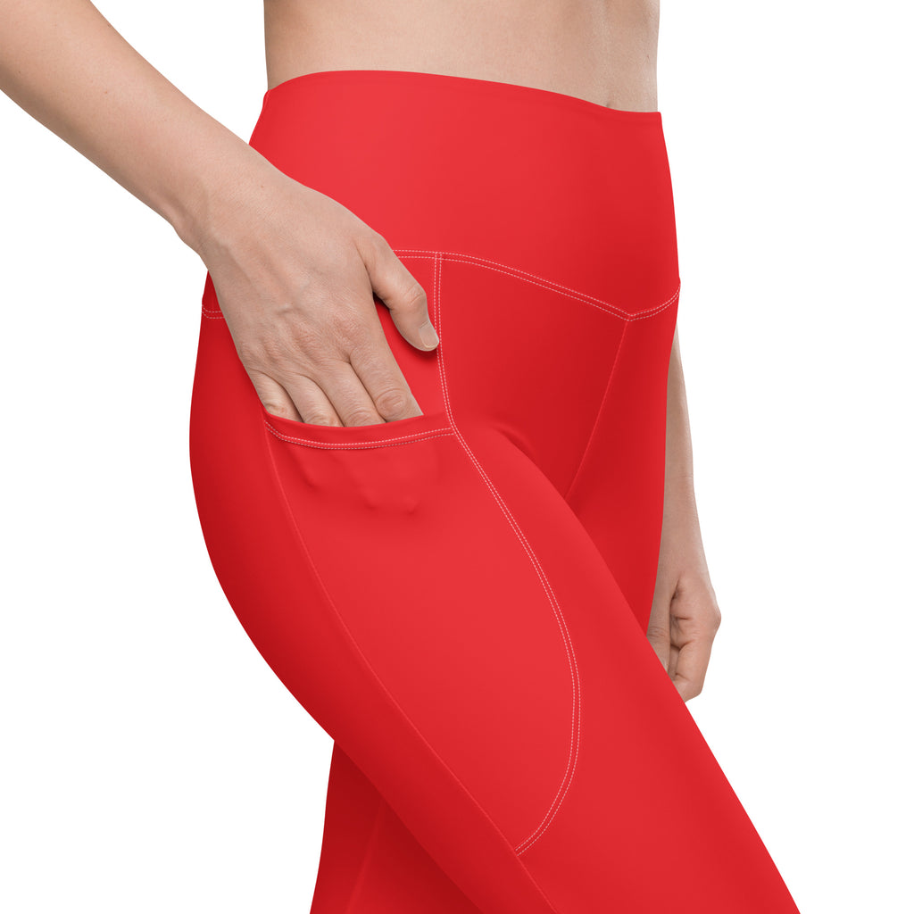 Women’s red high-waisted yoga leggings with pockets and soft compression fabric featuring white stitching seams
