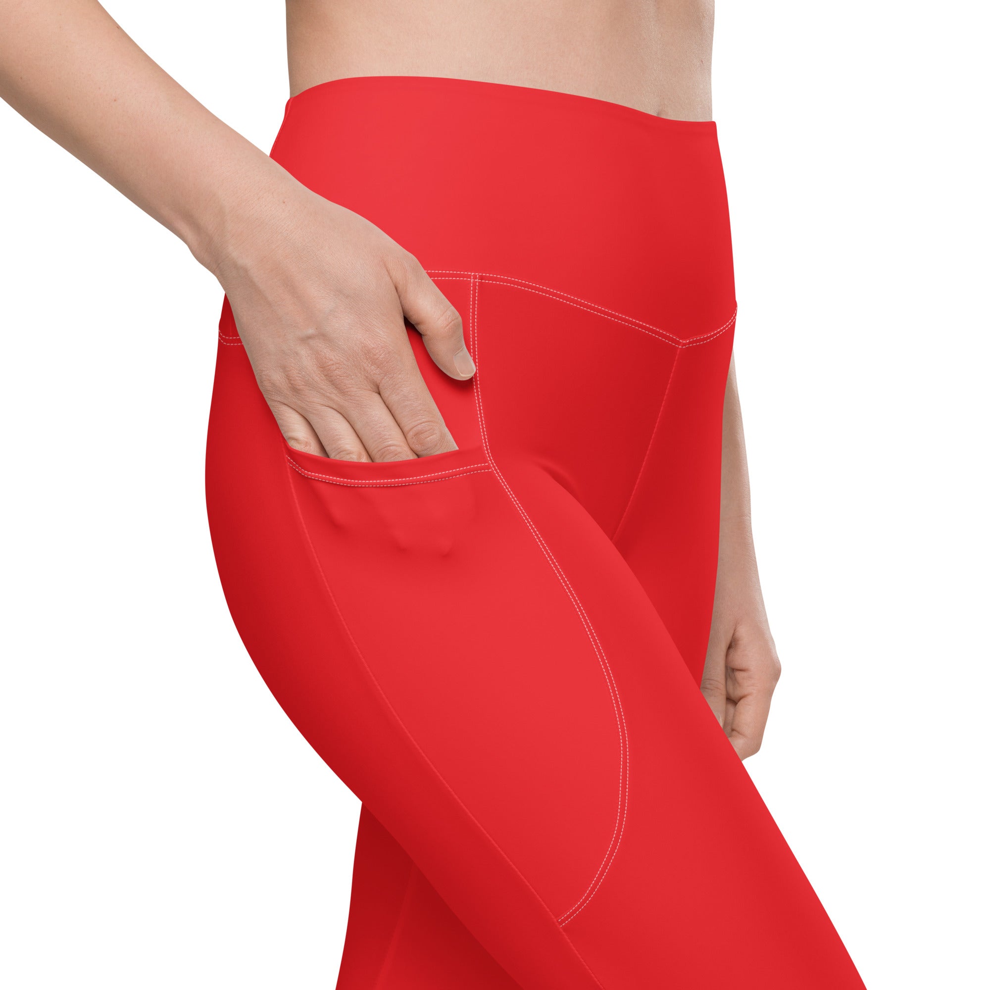 Women’s red high-waisted yoga leggings with pockets and soft compression fabric featuring white stitching seams